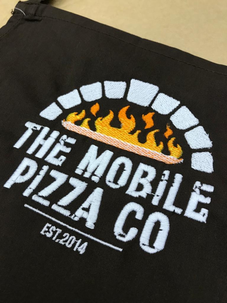 White printed customer branding on red workwear